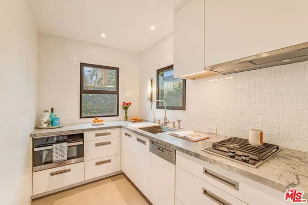 a kitchen with a stove and a sink