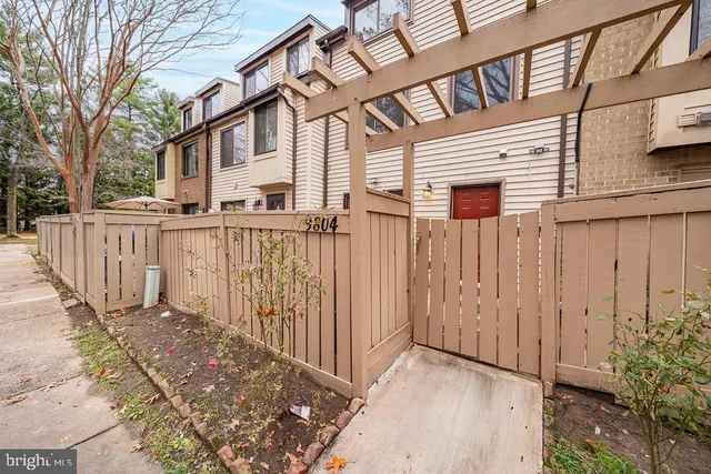 a view of a house with wooden floor and a fence