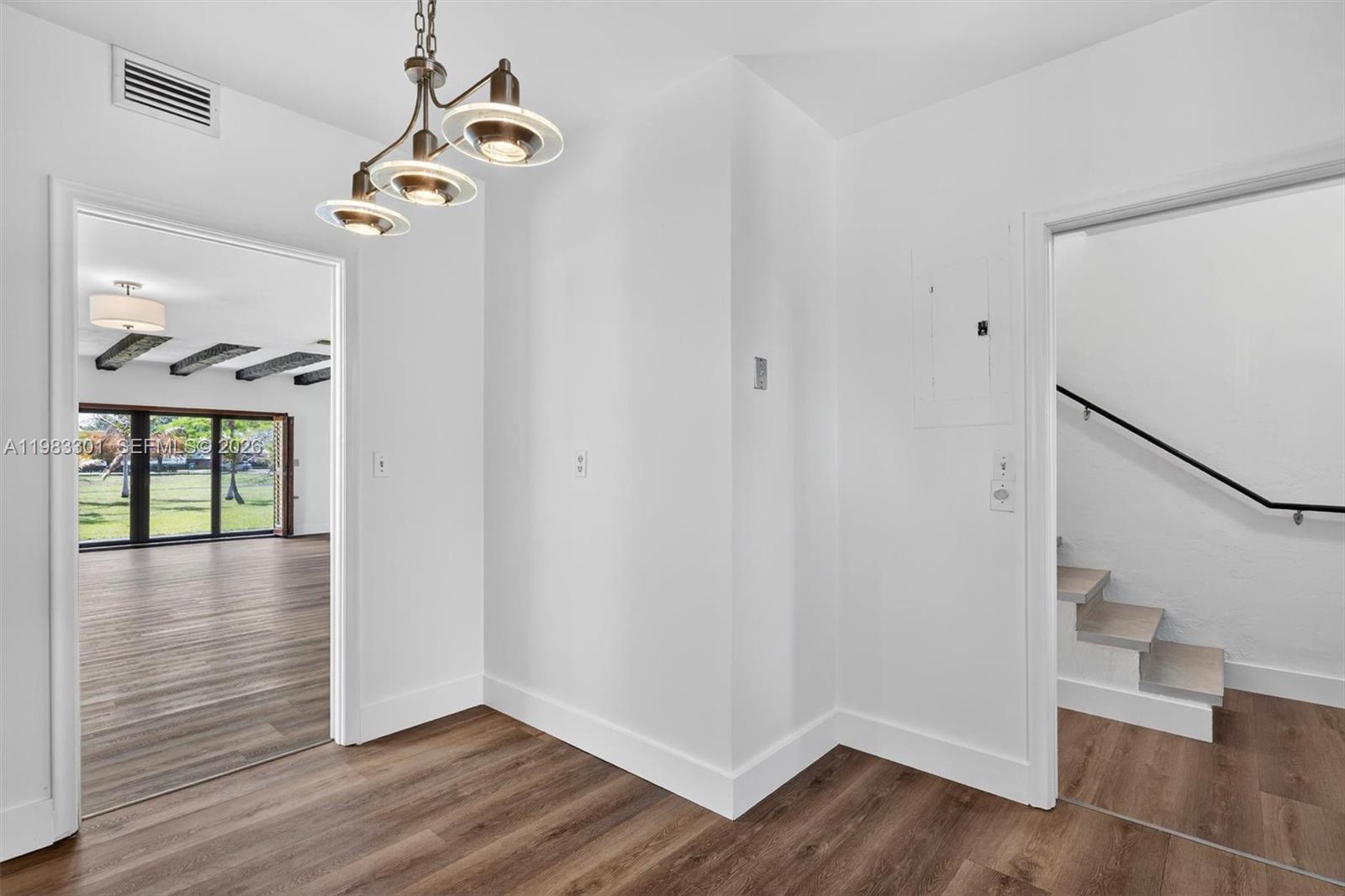 6190 Southwest 90th Court, Unit 1K Miami, FL 33173 - Photo 11 of 49 a view of an entryway with wooden floor