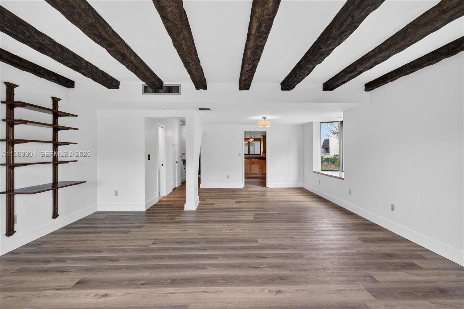 6190 Southwest 90th Court, Unit 1K Miami, FL 33173 - Photo 15 of 49 a view of an empty room with wooden floor and windows