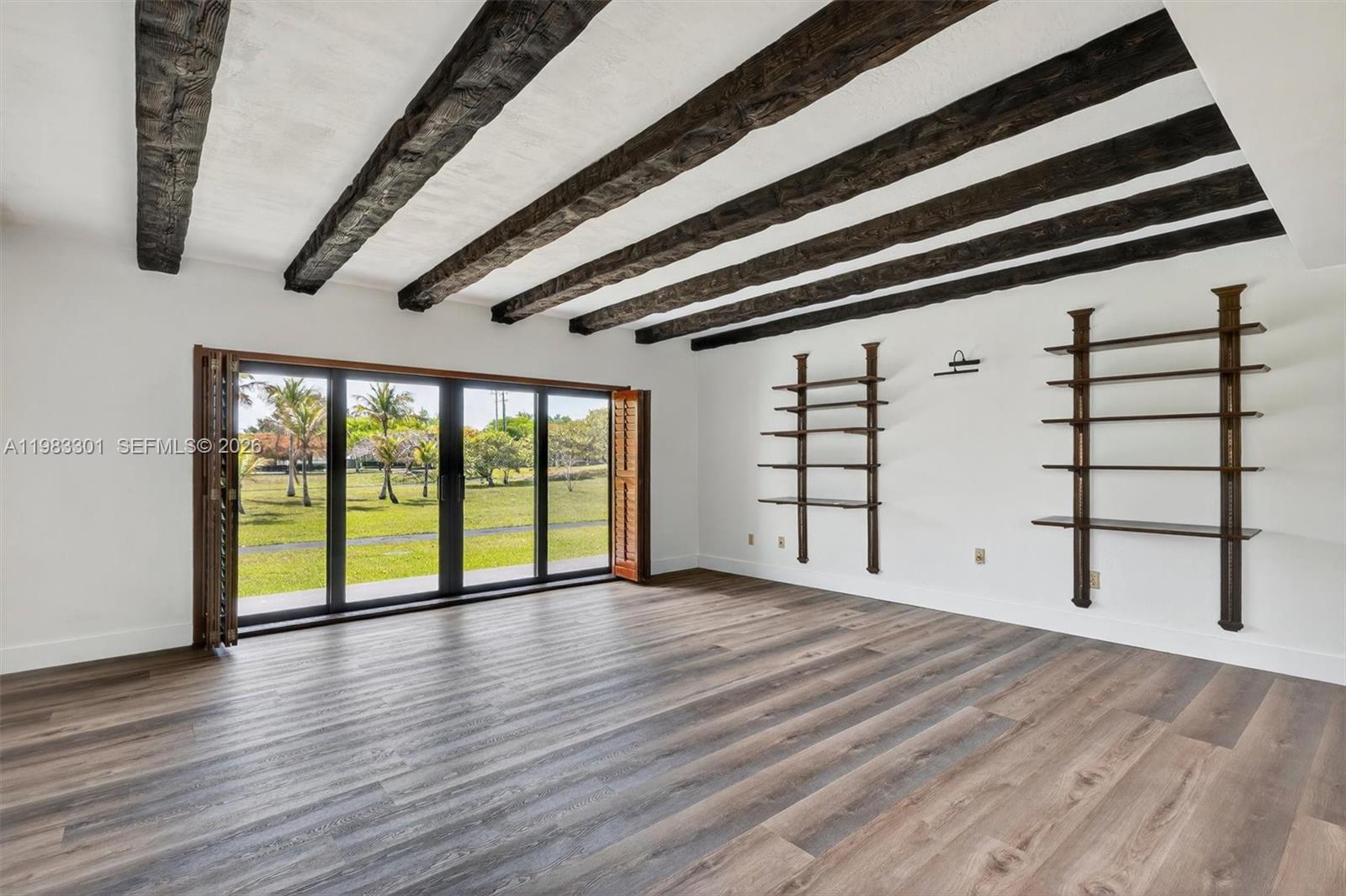 6190 Southwest 90th Court, Unit 1K Miami, FL 33173 - Photo 16 of 49 wooden floor in an empty room with a window
