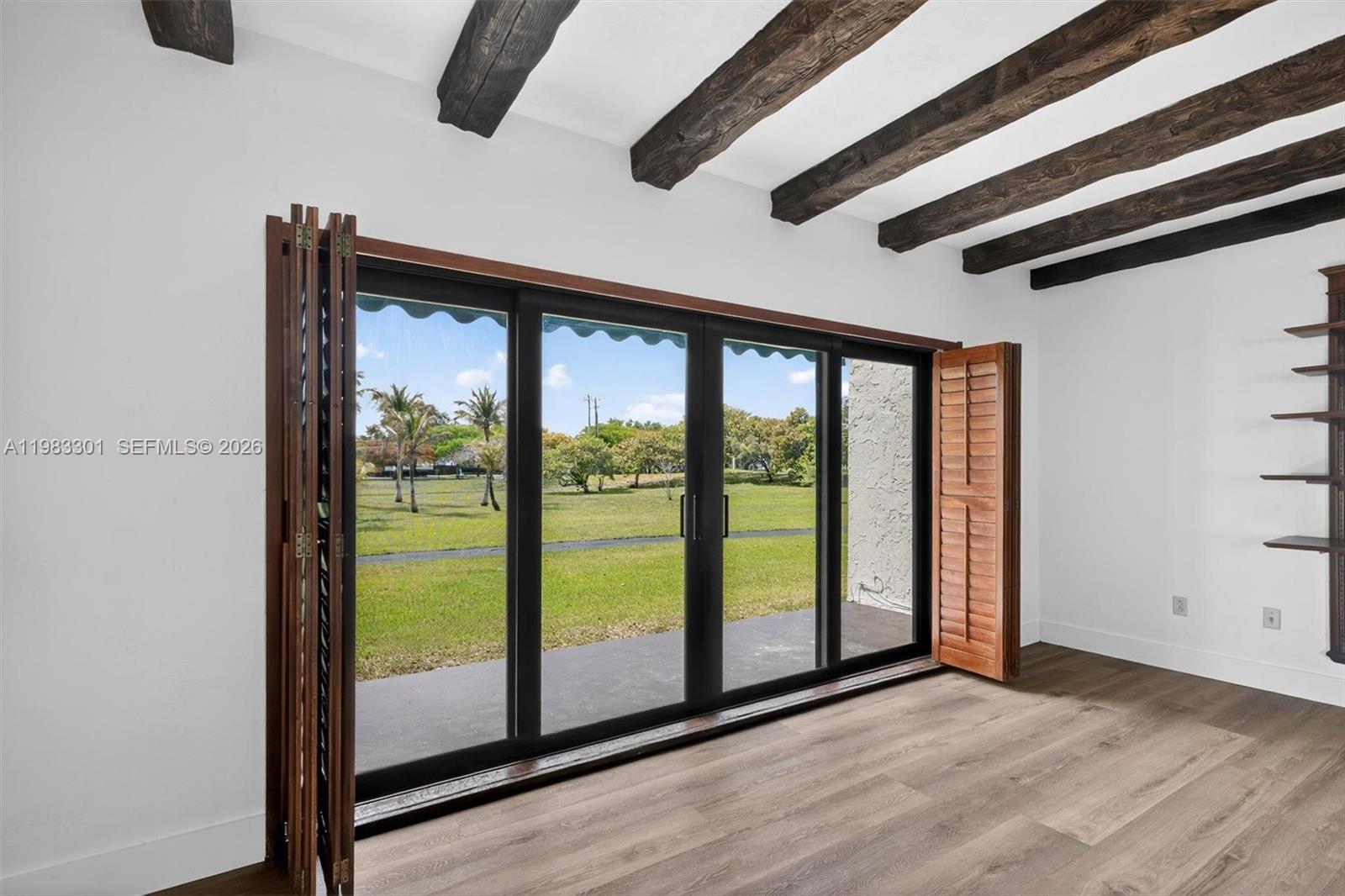 6190 Southwest 90th Court, Unit 1K Miami, FL 33173 - Photo 17 of 49 a view of a room with wooden floor and windows