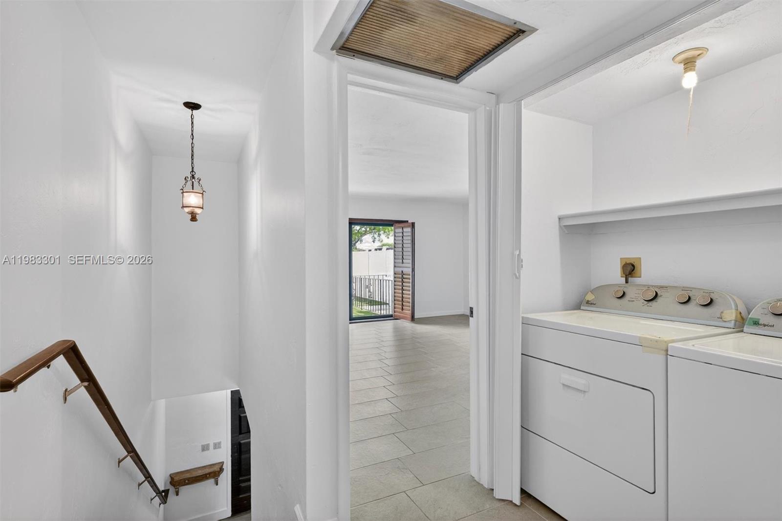 6190 Southwest 90th Court, Unit 1K Miami, FL 33173 - Photo 22 of 49 a hallway with cabinets and wooden floor
