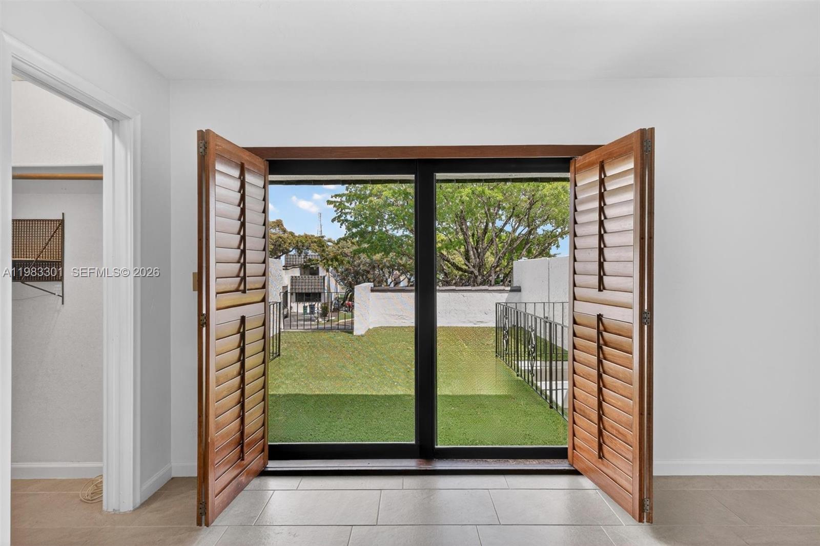 6190 Southwest 90th Court, Unit 1K Miami, FL 33173 - Photo 25 of 49 a room with a large window and a rug