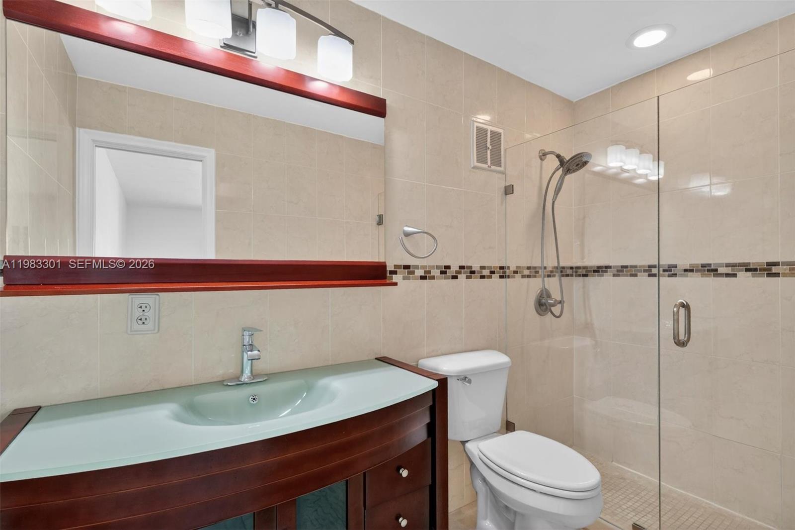 6190 Southwest 90th Court, Unit 1K Miami, FL 33173 - Photo 30 of 49 a bathroom with a sink a toilet and shower