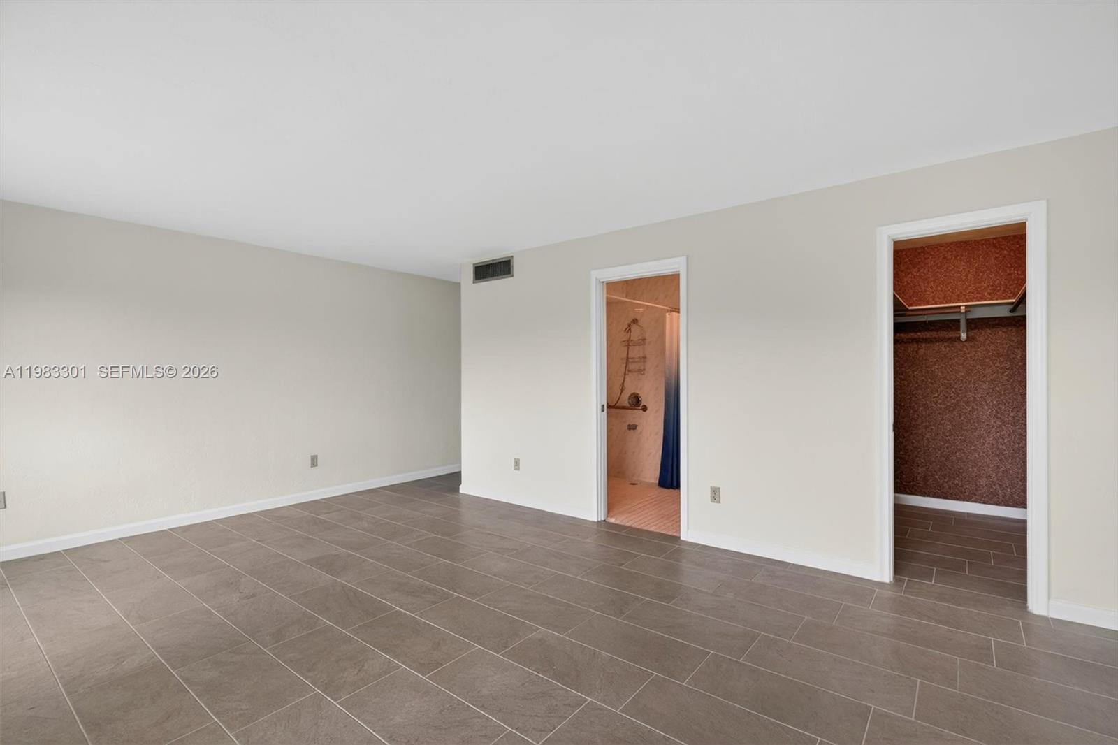 6190 Southwest 90th Court, Unit 1K Miami, FL 33173 - Photo 31 of 49 an empty room with closet