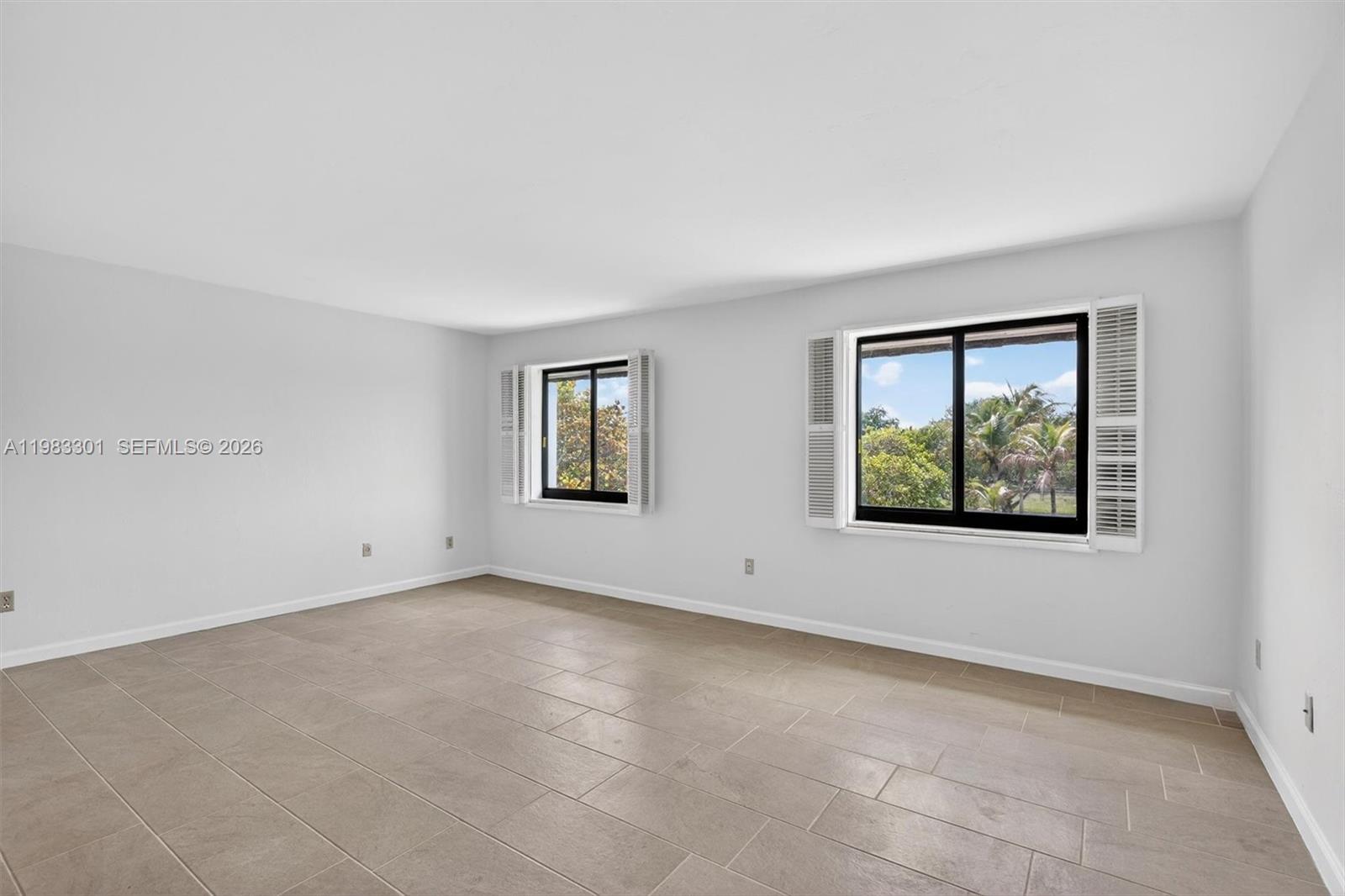6190 Southwest 90th Court, Unit 1K Miami, FL 33173 - Photo 32 of 49 an empty room with windows