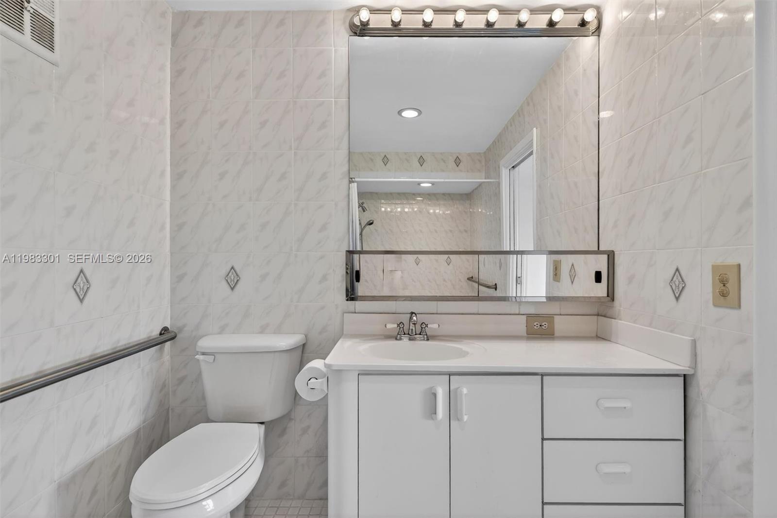 6190 Southwest 90th Court, Unit 1K Miami, FL 33173 - Photo 35 of 49 a bathroom with a sink a toilet and shower