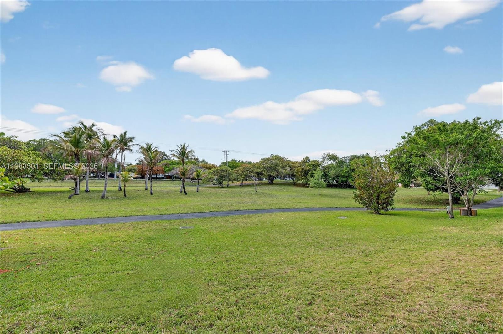 6190 Southwest 90th Court, Unit 1K Miami, FL 33173 - Photo 37 of 49 a view of a golf course with a lake