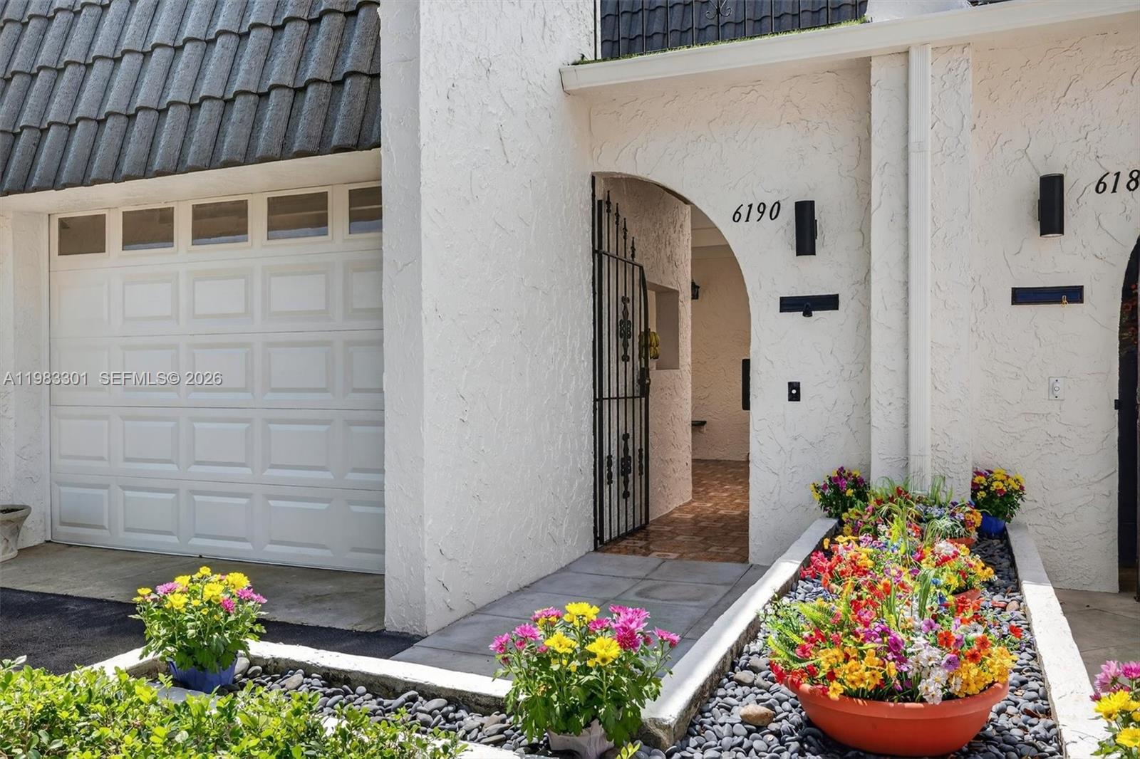 6190 Southwest 90th Court, Unit 1K Miami, FL 33173 - Photo 4 of 49 a front view of a house with a garden