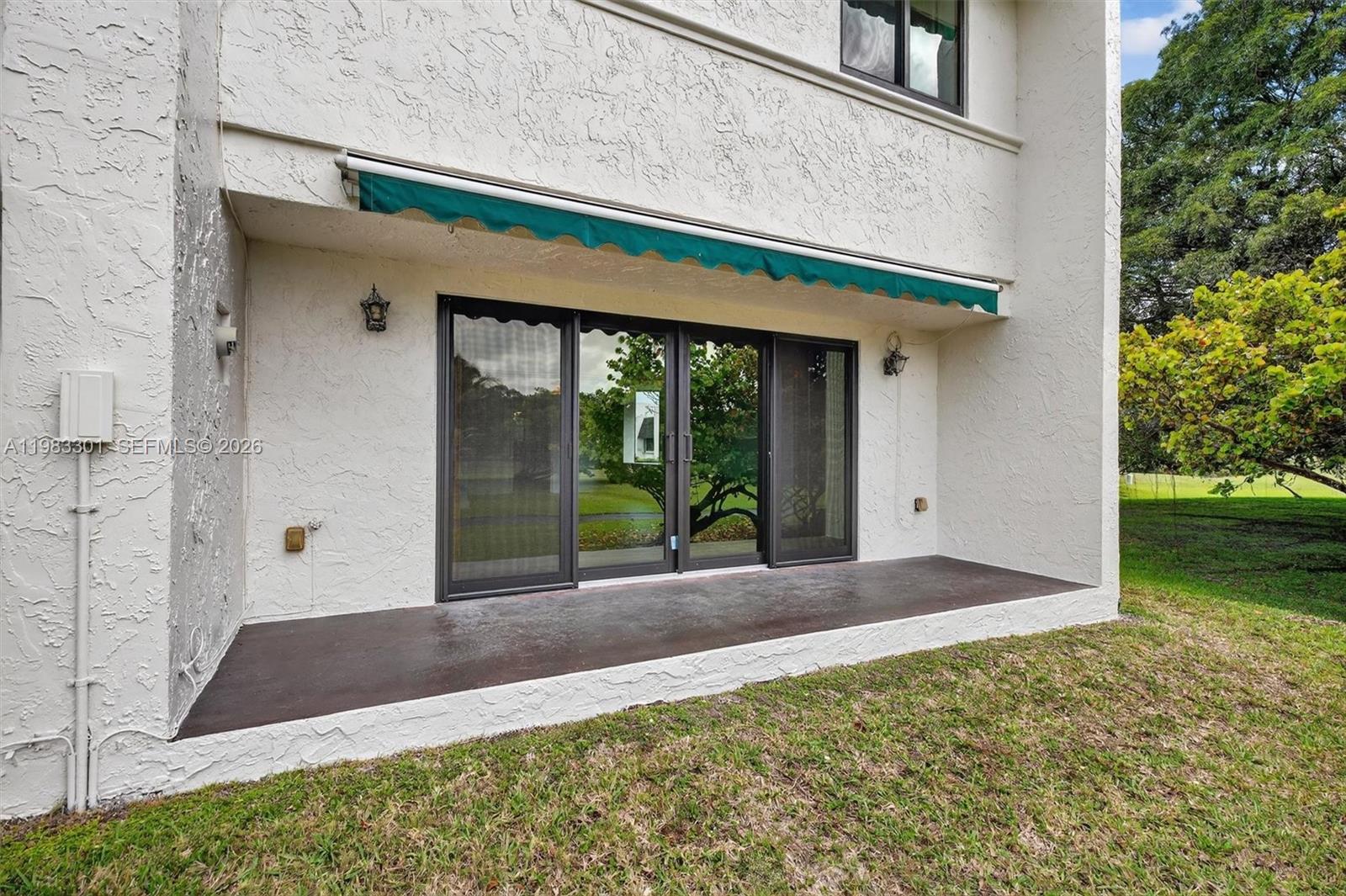6190 Southwest 90th Court, Unit 1K Miami, FL 33173 - Photo 41 of 49 a front view of a house with a yard and garage