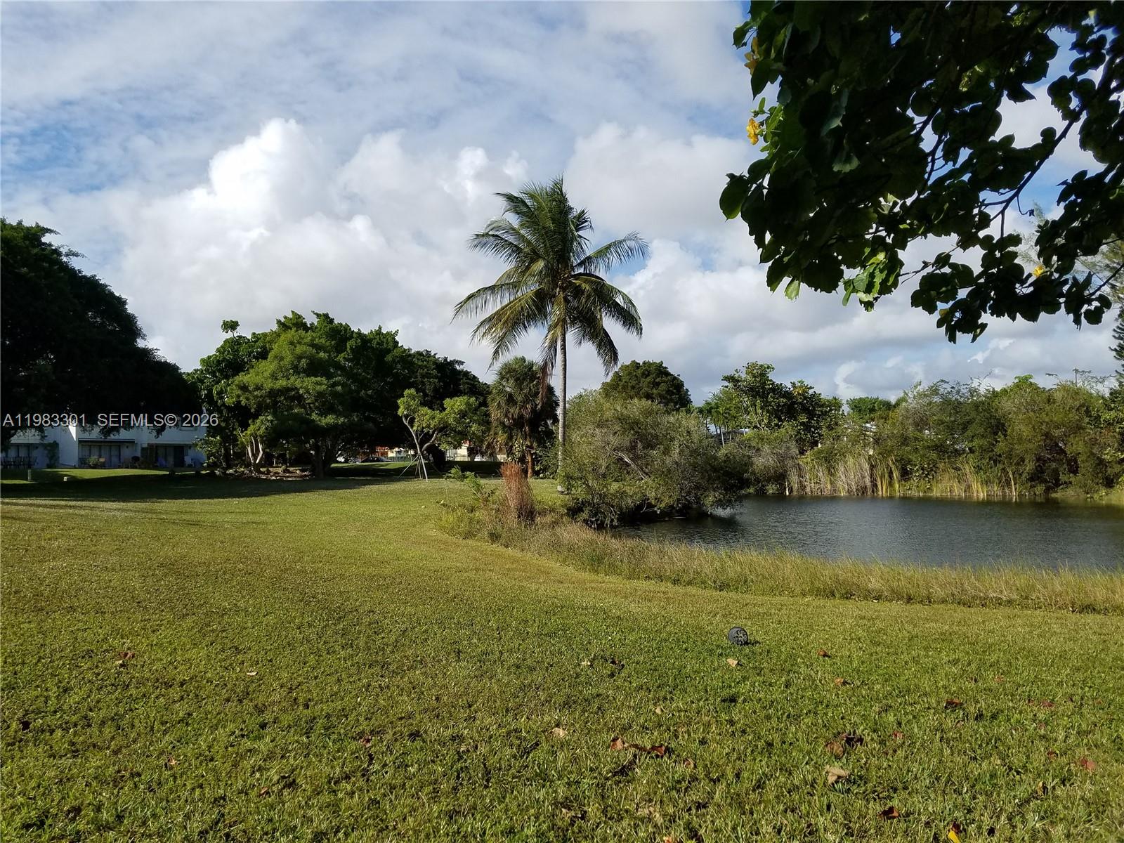 6190 Southwest 90th Court, Unit 1K Miami, FL 33173 - Photo 42 of 49 a view of a lake with houses