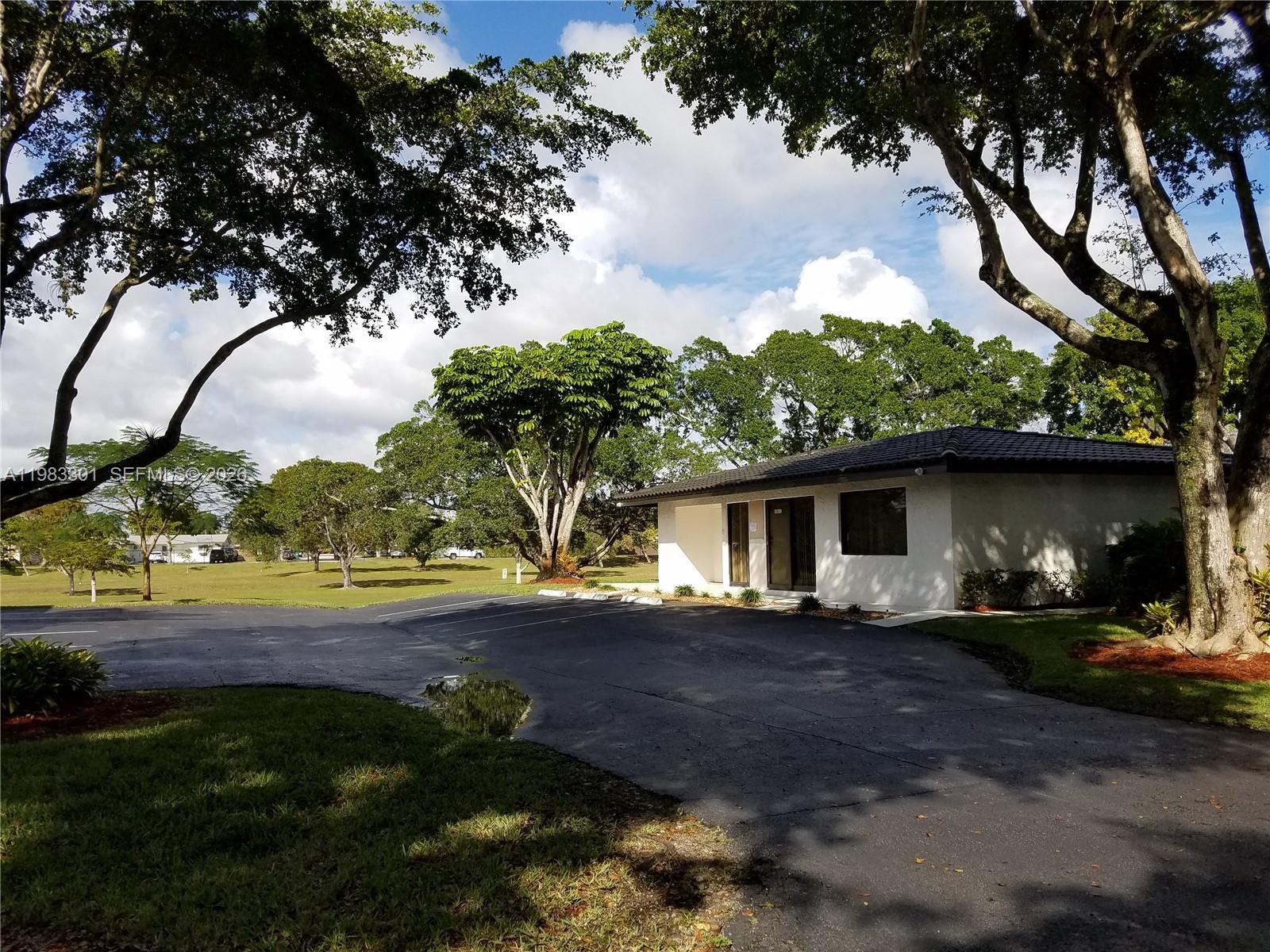 6190 Southwest 90th Court, Unit 1K Miami, FL 33173 - Photo 43 of 49 a front view of a house with yard and mountain view