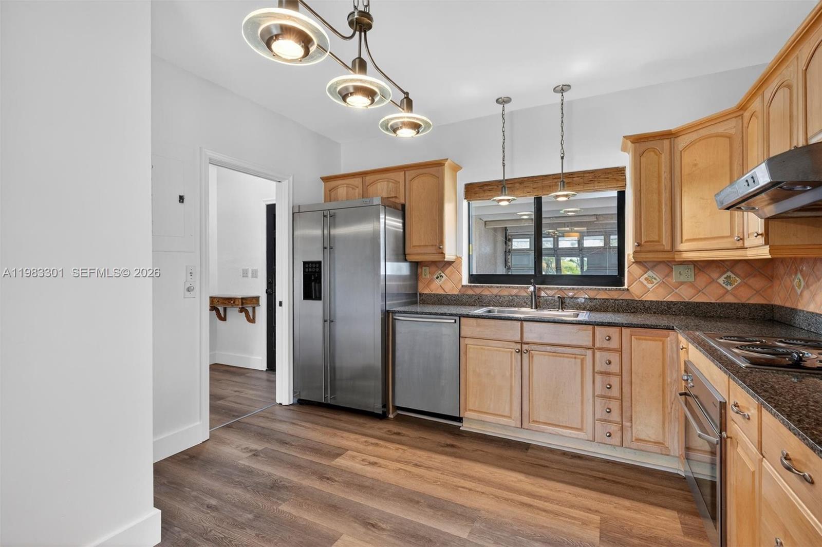 6190 Southwest 90th Court, Unit 1K Miami, FL 33173 - Photo 9 of 49 a kitchen with stainless steel appliances granite countertop a refrigerator a stove and a sink