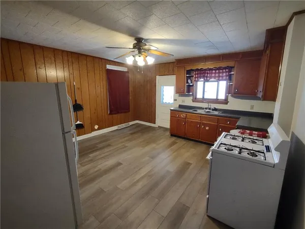 a view of kitchen with furniture and wooden floor