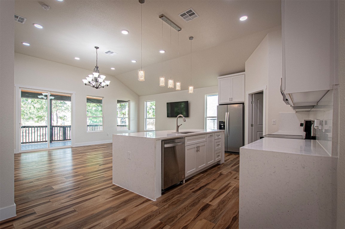 106 Passion Vine Rd Dale Dale, TX 78616 - Photo 23 of 23 a large kitchen with granite countertop a large counter top a sink stainless steel appliances and cabinets