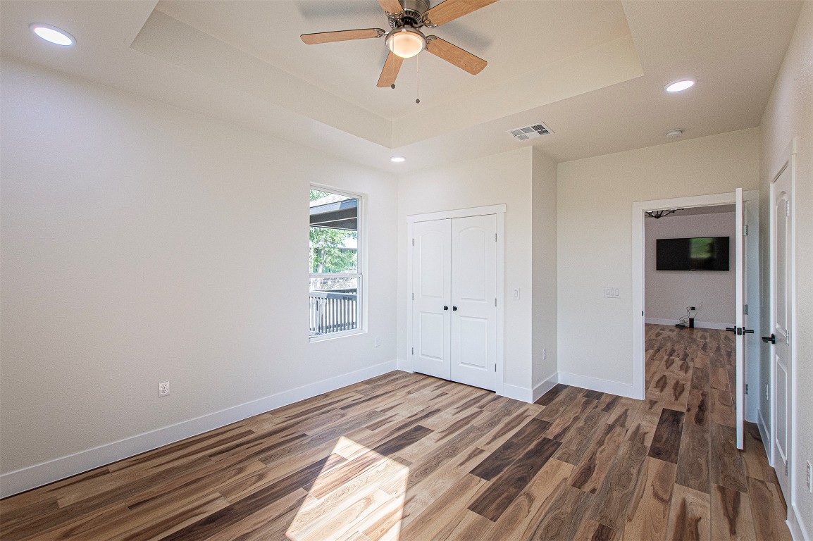 106 Passion Vine Rd Dale Dale, TX 78616 - Photo 12 of 23 a view of a bedroom with a bed and wooden floor