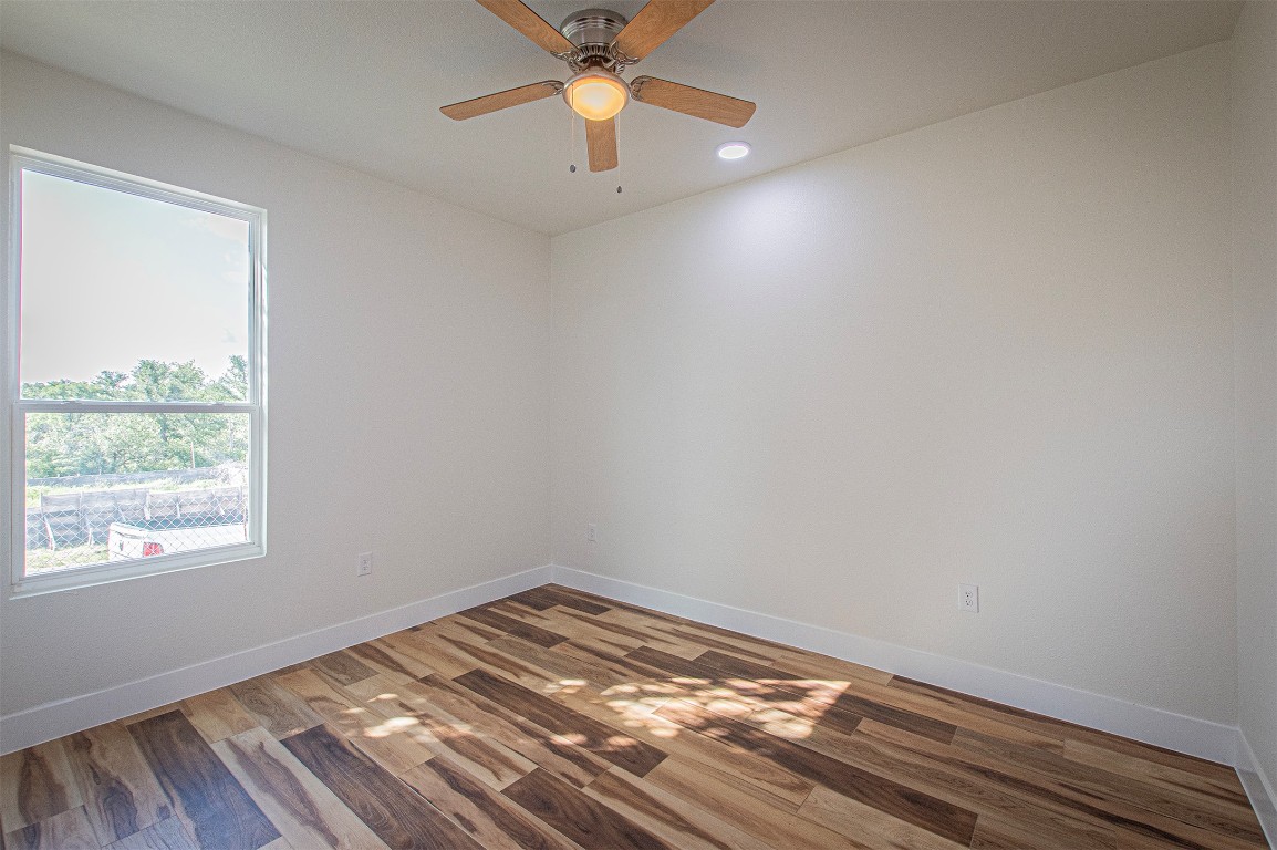 106 Passion Vine Rd Dale Dale, TX 78616 - Photo 15 of 23 wooden floor in an empty room with a window