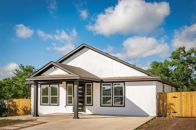 a large kitchen with granite countertop a large counter top a sink stainless steel appliances and cabinets