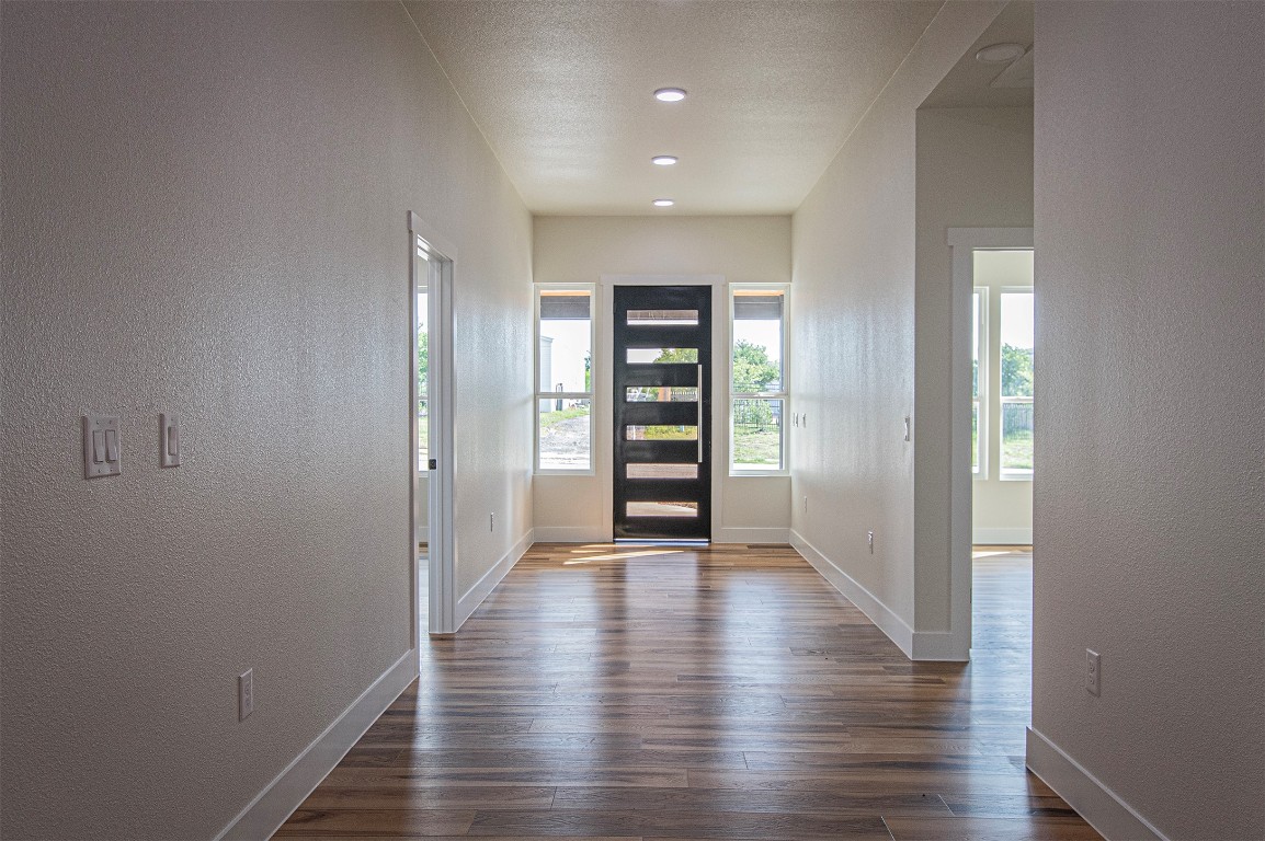106 Passion Vine Rd Dale Dale, TX 78616 - Photo 4 of 23 a view of an empty room with wooden floor and closet