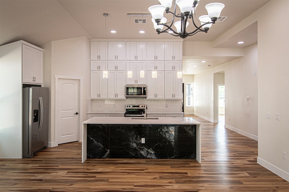 106 Passion Vine Rd Dale Dale, TX 78616 - Photo 6 of 23 a kitchen with stainless steel appliances granite countertop a stove refrigerator and cabinets