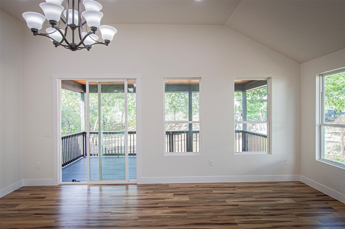 106 Passion Vine Rd Dale Dale, TX 78616 - Photo 7 of 23 a view of an empty room with wooden floor and fan