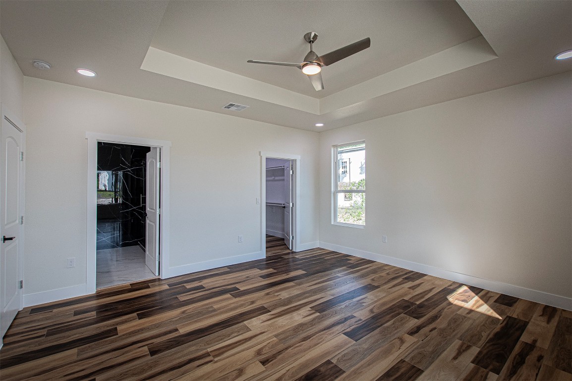 106 Passion Vine Rd Dale Dale, TX 78616 - Photo 9 of 23 a view of an empty room with window and wooden floor