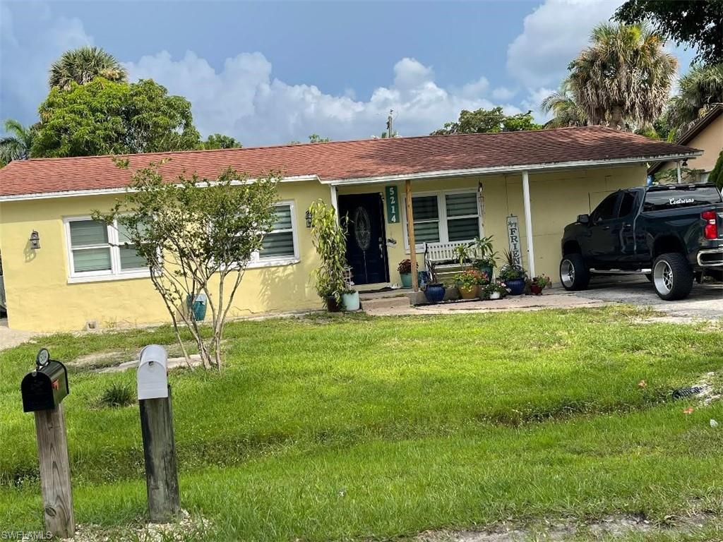a front view of house with yard and outdoor seating