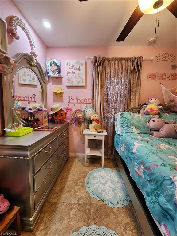 5214 Carlton Street Naples, FL 34113 - Photo 12 of 20 a bedroom with a bed and a chandelier