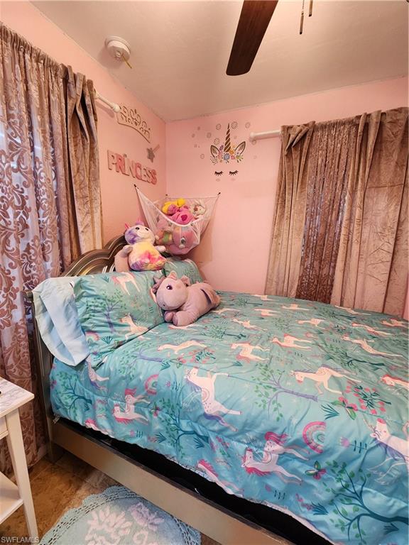 5214 Carlton Street Naples, FL 34113 - Photo 13 of 20 a bedroom with bed and wooden floor