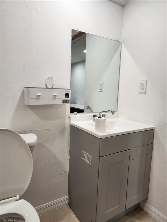 5214 Carlton Street Naples, FL 34113 - Photo 19 of 20 a bathroom with a sink mirror and toilet