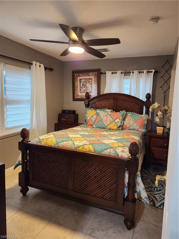 5214 Carlton Street Naples, FL 34113 - Photo 6 of 20 a bedroom with a bed and a dresser next to a window