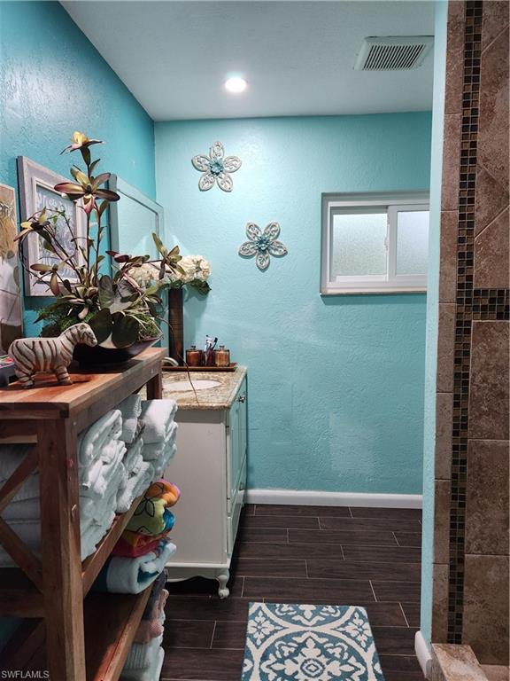 5214 Carlton Street Naples, FL 34113 - Photo 7 of 20 a room with a mirror and a wooden floor