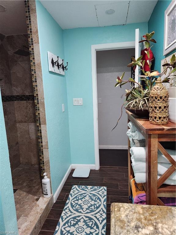 5214 Carlton Street Naples, FL 34113 - Photo 9 of 20 a living room with a rug and a potted plant