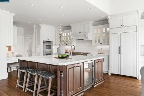 a living room with furniture and a view of kitchen