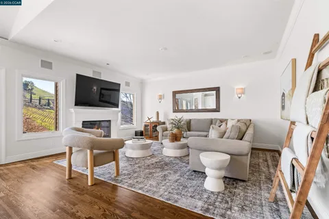 a living room with kitchen island a sink cabinets and wooden floor