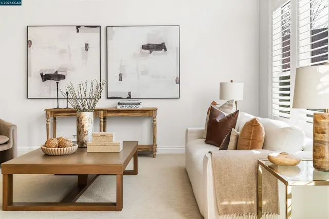 a living room with furniture a fireplace and a large window