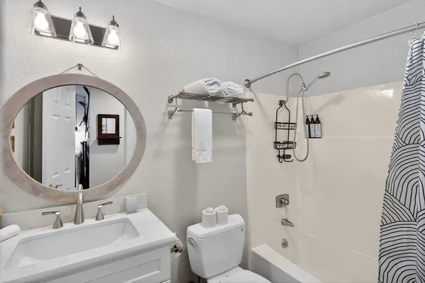 a bathroom with a sink toilet and shower