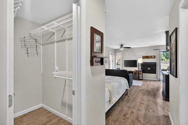 a en suite spacious bedroom with a bed and wooden floor