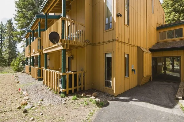 a view of a house with wooden fence
