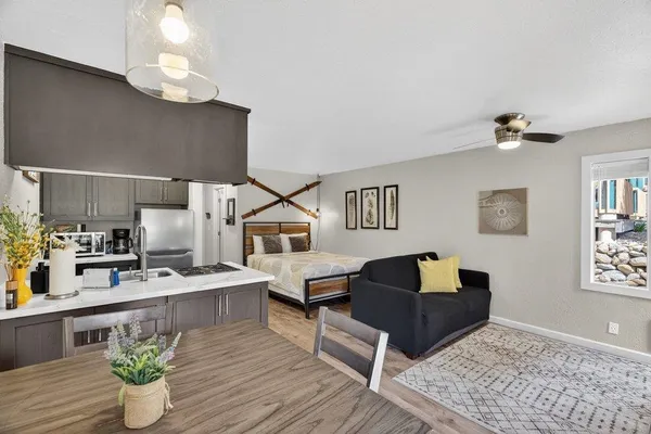 a living room with furniture kitchen view and a table