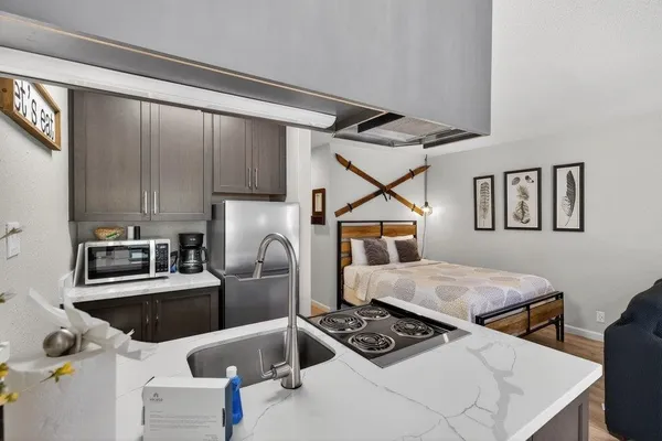 a bedroom with furniture and a stove