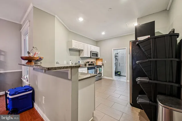 a kitchen with a refrigerator and a sink