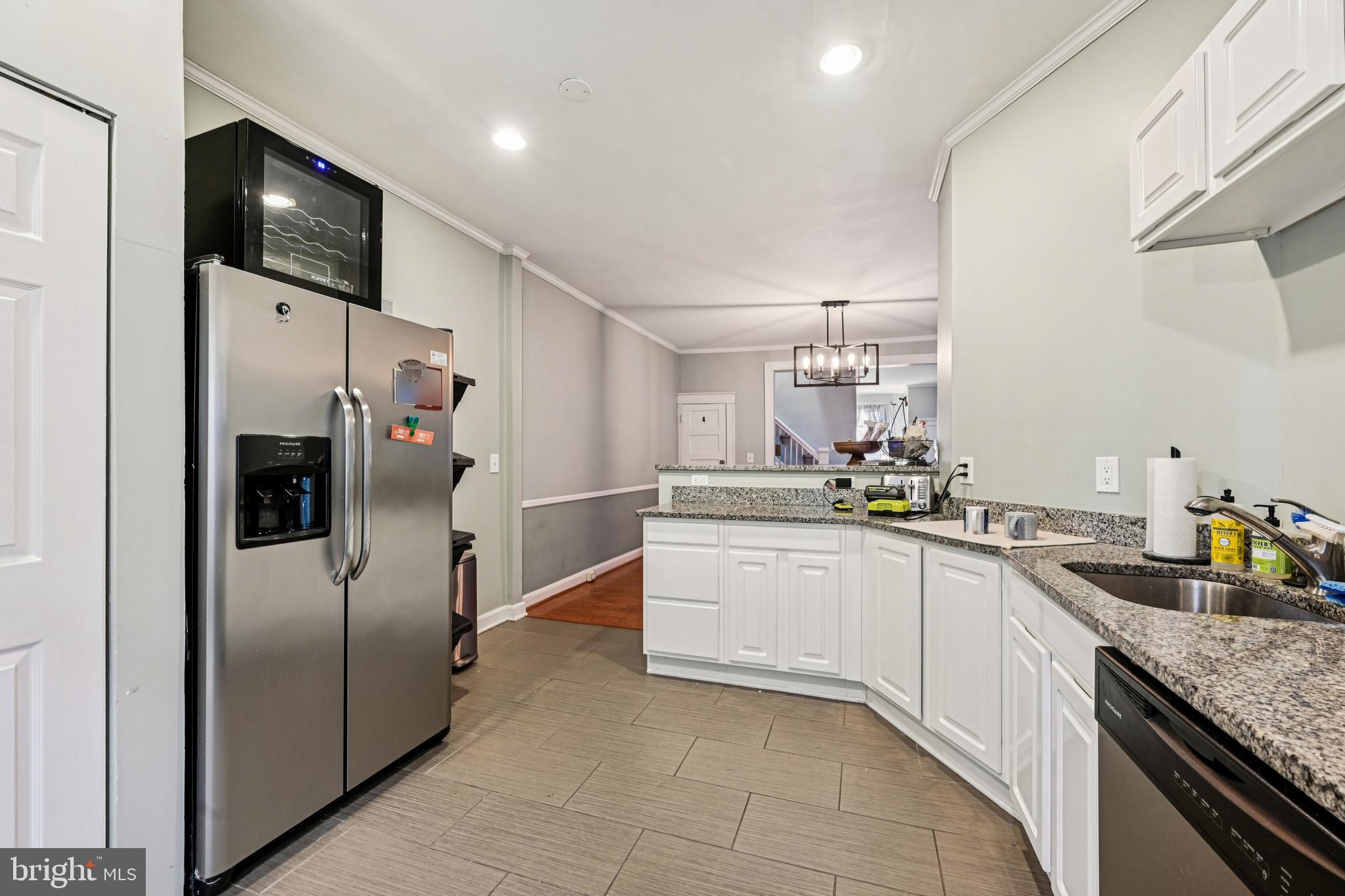 616 East 33rd Street Baltimore, MD 21218 - Photo 17 of 44 a kitchen with granite countertop a refrigerator and a sink