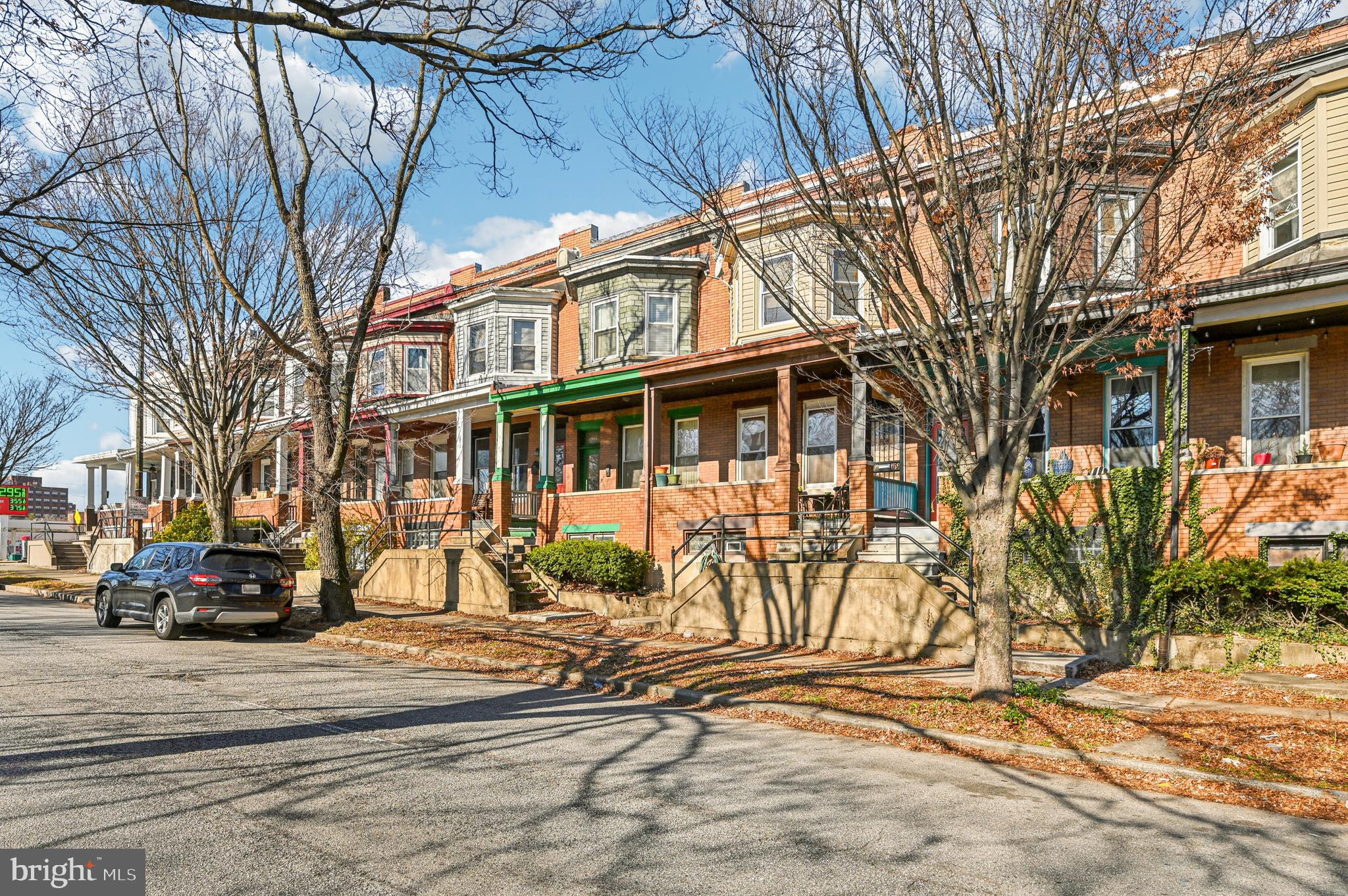 616 East 33rd Street Baltimore, MD 21218 - Photo 2 of 44 a view of a brick house with many windows next to a road
