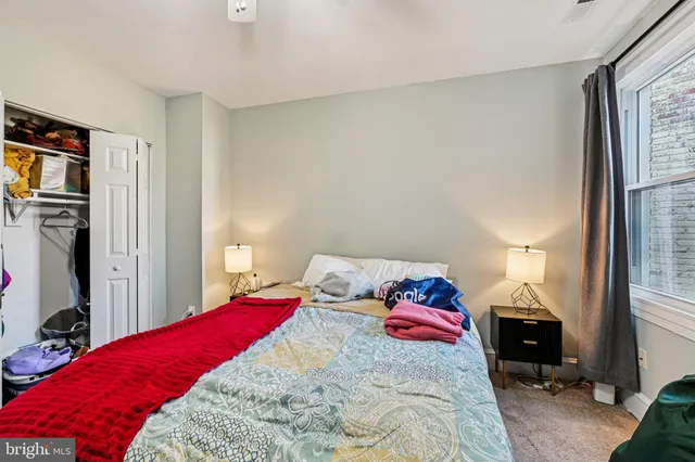 a bedroom with a bed and a lamp