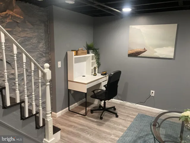 a view of a room with furniture and wooden floor