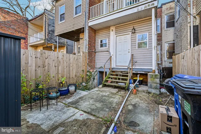 a view of a house with wooden door and stairs
