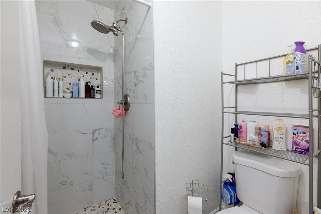 3640 North Walnut Road Las Vegas, NV 89115 - Photo 30 of 38 A well-appointed shower space, thoughtfully designed with a tiled niche for bath essentials.
