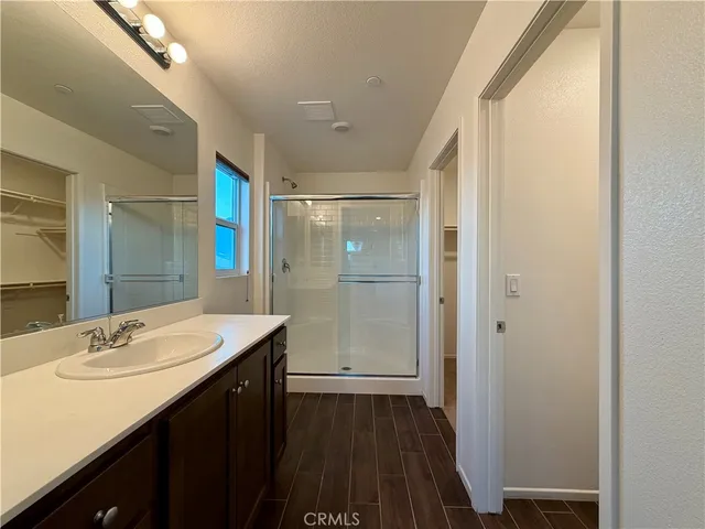a bathroom with a granite countertop shower and a toilet